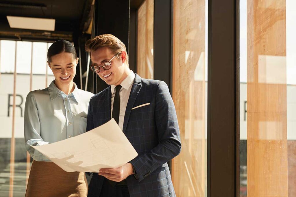 A couple and their agent examining the kitchen and appliances during a daytime home tour.